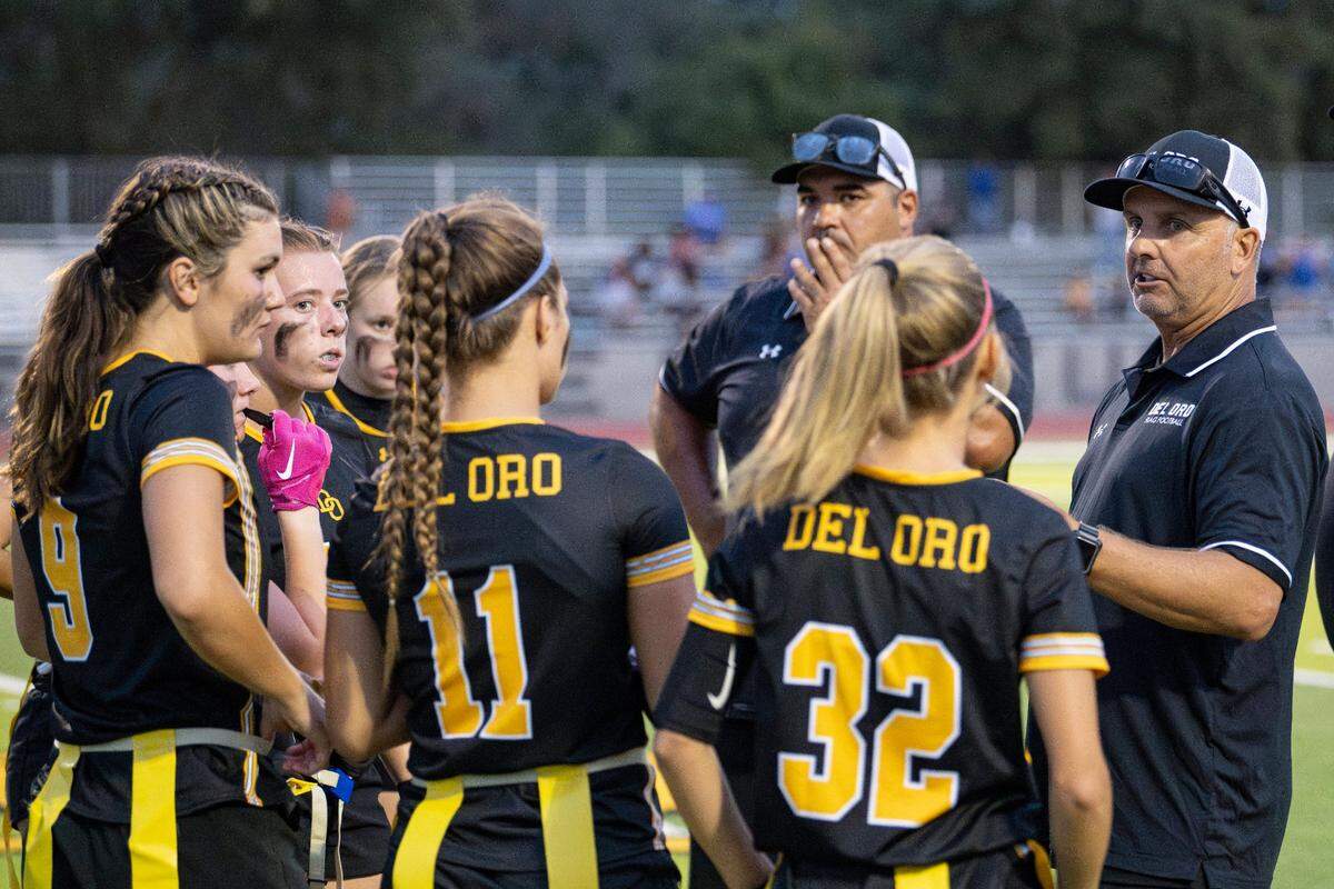 Del Oro girls flag football head coach Steve Birch speaks with his team during a timeout at Del Oro High School on Monday.