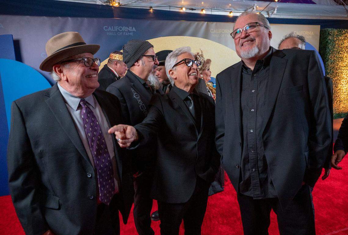 Members of the iconic Chicano rock band Los Lobos stand on the red carpet on Tuesday as one of this year’s inductees into the California Hall of Fame.