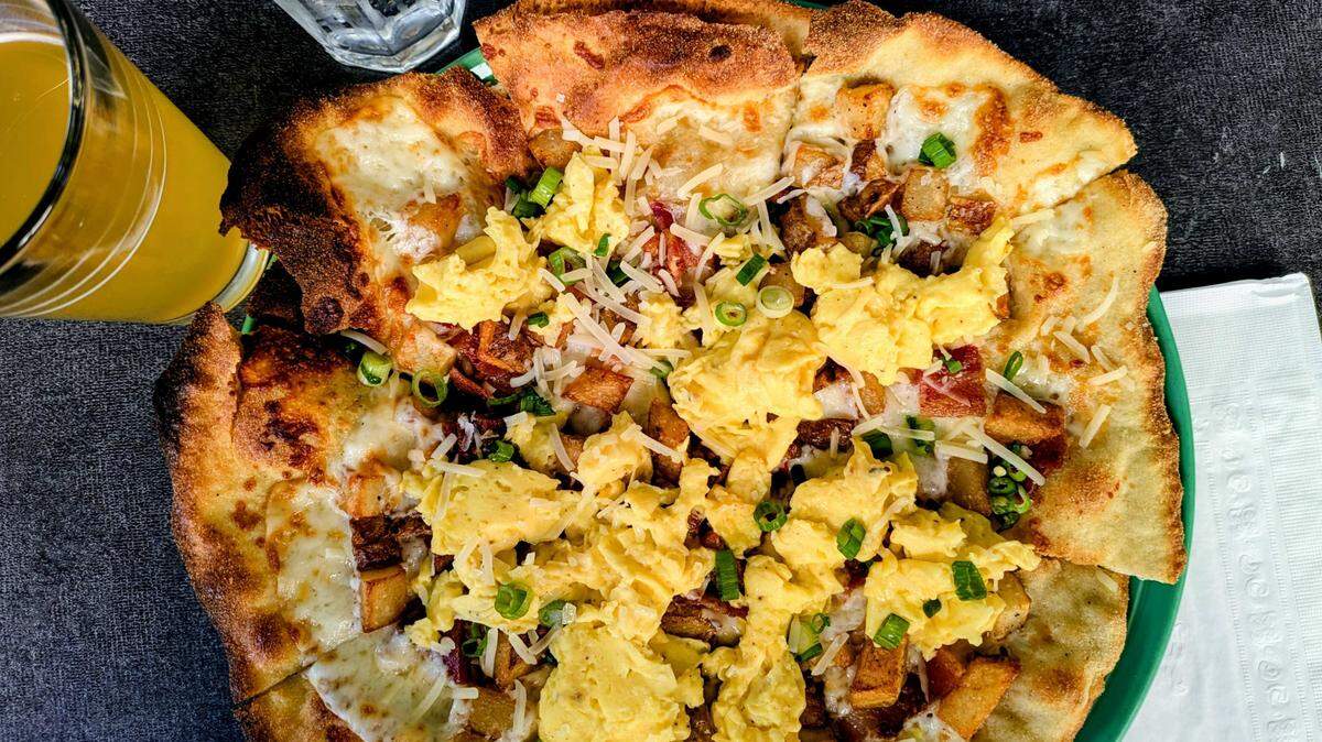 The Golden Bear’s breakfast pizza piles fluffy scrambled eggs on top of a crispy thin crust with green onions, bacon and mozzarella.