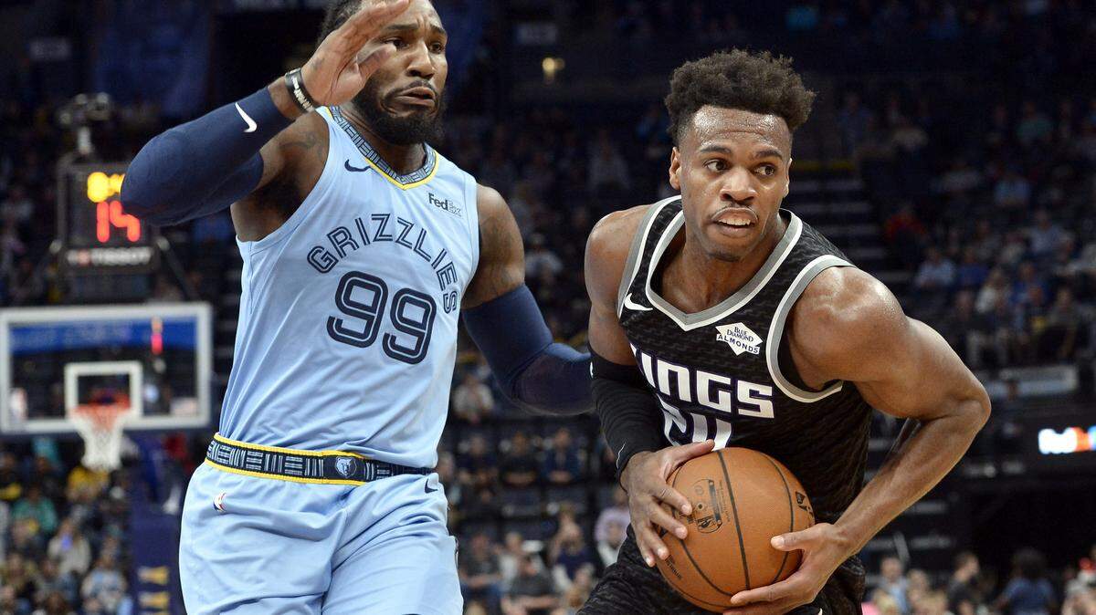 Sacramento Kings guard Buddy Hield (24) handles the ball against Memphis Grizzlies forward Jae Crowder (99) in the first half of an NBA basketball game Saturday, Dec. 21, 2019, in Memphis, Tenn. (AP Photo/Brandon Dill)