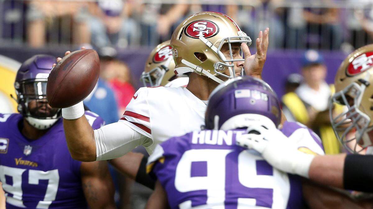 Quarterback Jimmy Garoppolo throws a pass during the 49ers’ season opener against the Minnesota Vikings on Sunday in Minneapolis.