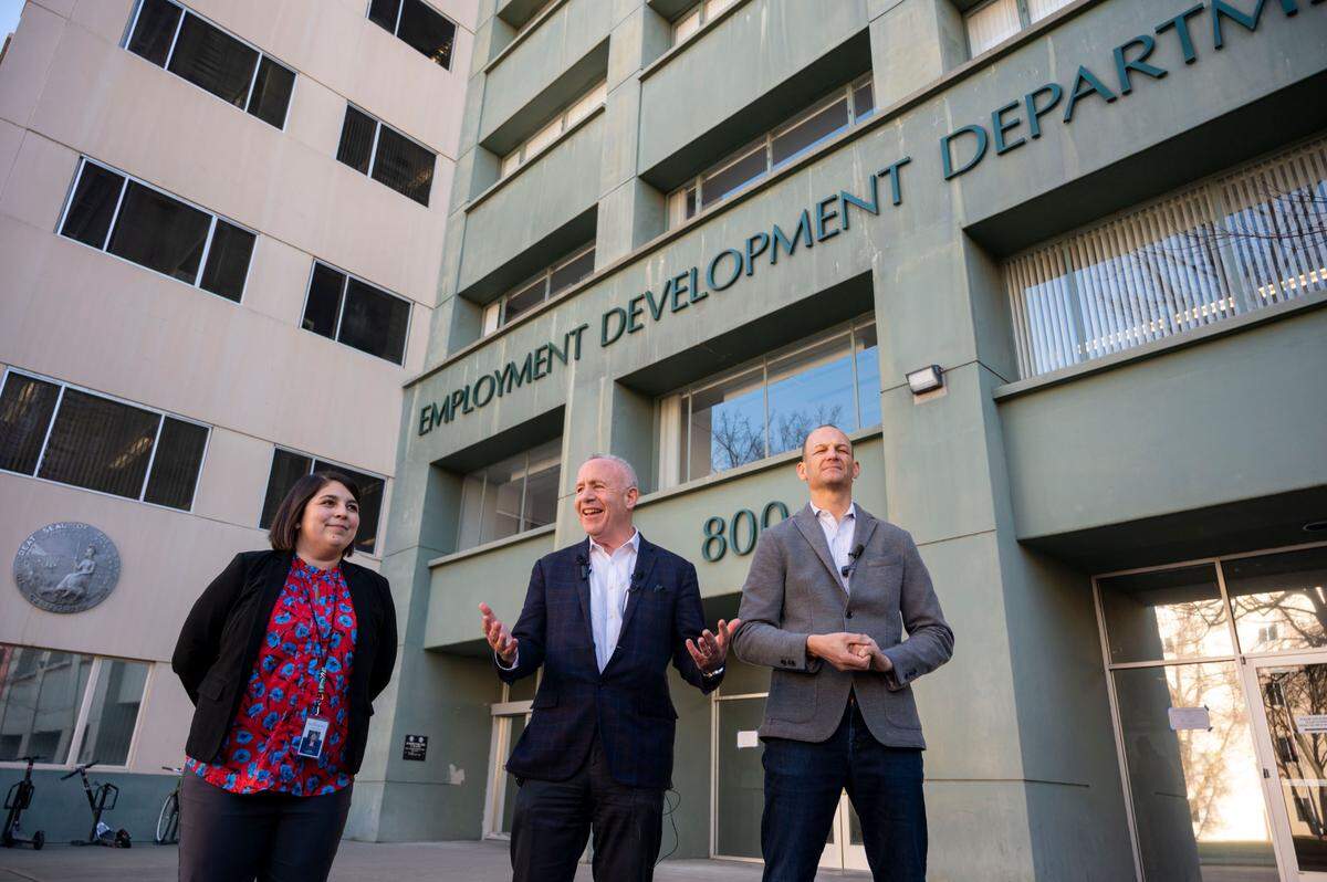 Then-Sacramento City Councilwoman Katie Valenzuela, Mayor Darrell Steinberg and Assemblyman Kevin McCarty comment in front of the Employment Development Department building in Sacramento in 2023, after the announcement that it was one of three state office buildings being made available for downtown housing. The building will now be converted into a downtown campus for Sacramento State.