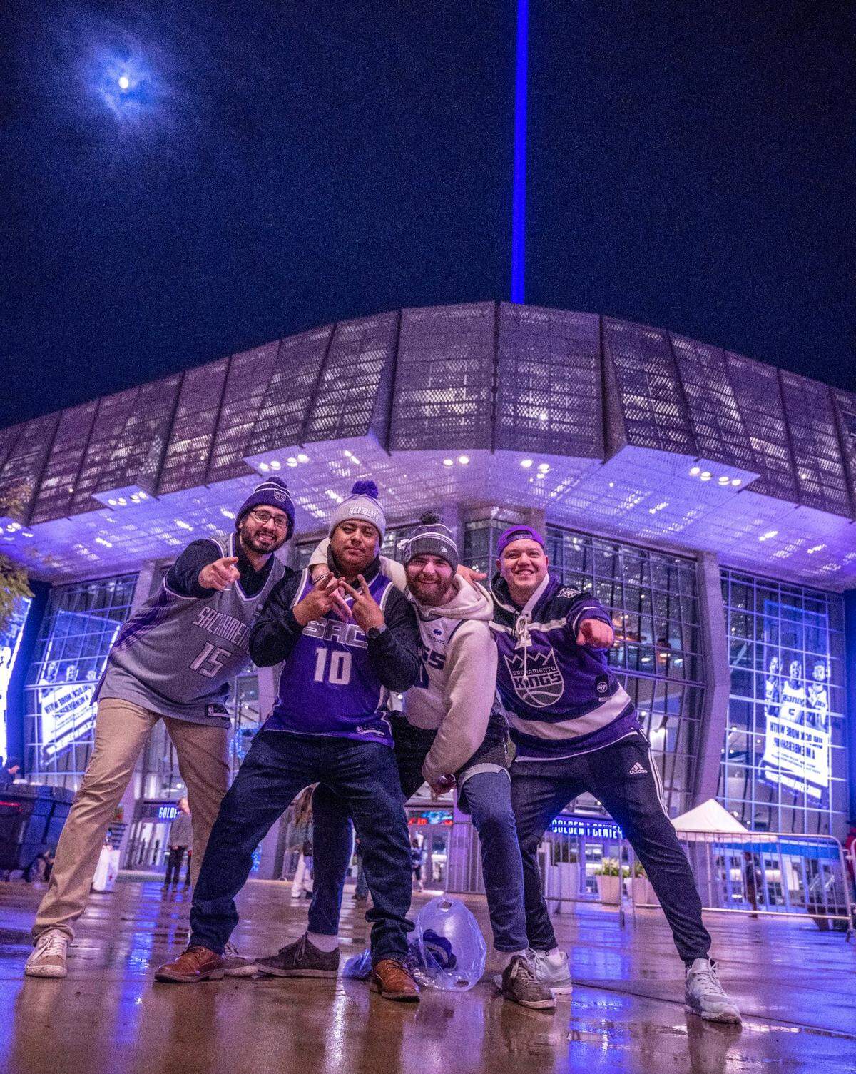 Sacramento Kings fans Farham Kakar, Rigoberto Vasquez, Nijal Martin and Isaias Edel celebrate the Kings’ 110-101 victory against the Chicago Bulls in front of the victory beam on Sunday, Dec. 4, 2022, at Golden 1 Center in Sacramento.