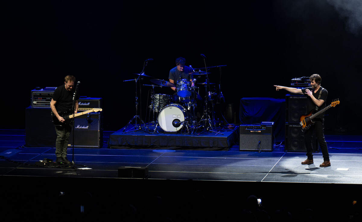 Bassist Keanu Reeves points to lead vocalist Bret Domrose during their performance as Dogstar on Saturday, Sept. 14, 2024, at the Hard Rock Live Sacramento near Wheatland.
