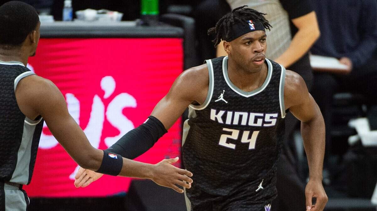 Sacramento Kings guard Buddy Hield (24) is congratulated by Sacramento Kings guard De’Aaron Fox (5) after basket in the first quarter during a game at Golden 1 Center on Sunday, Feb. 28, 2021 in Sacramento.