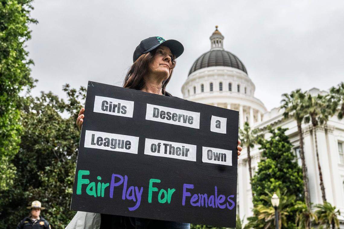 Lisa Smith, of Santa Cruz, holds a sign on April 1 during a rally at the state Capitol for two bills that would block transgender student athletes from participating in sports. An Assembly committee heard public comment on the bills later in the day.