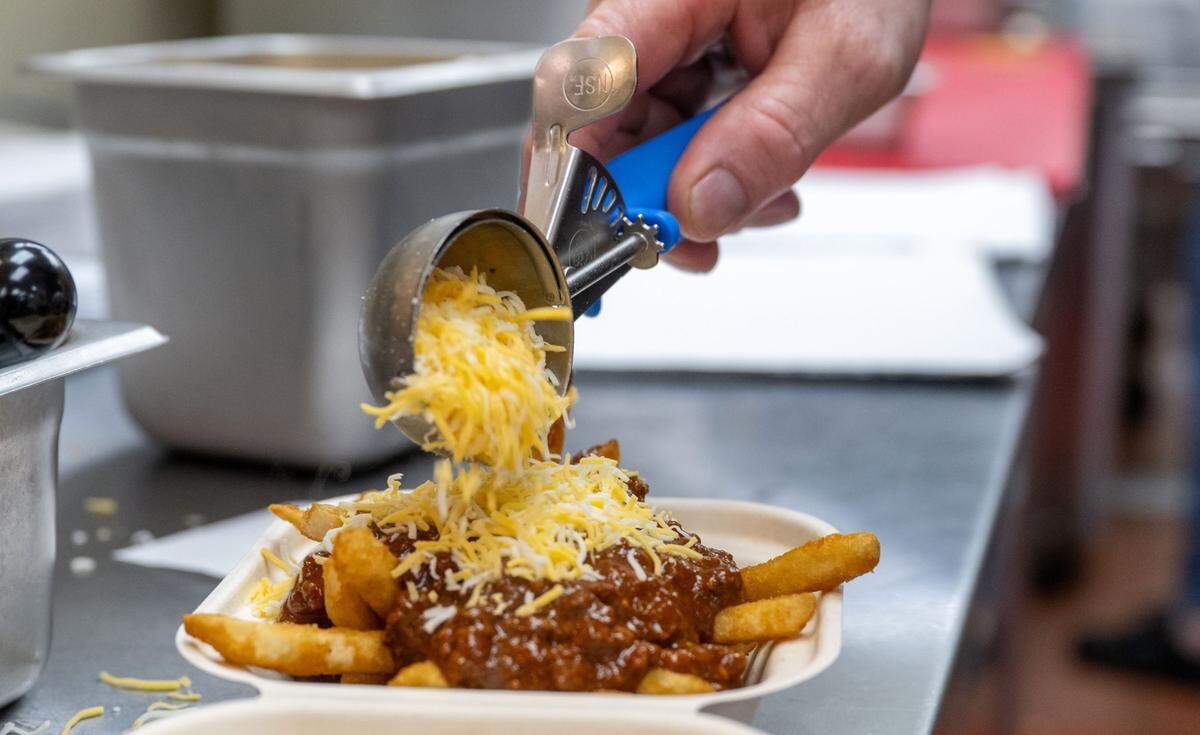 An order of fries with chili is prepared at Lucky’s Drive-In restaurant on Thursday, March 6, 2025.