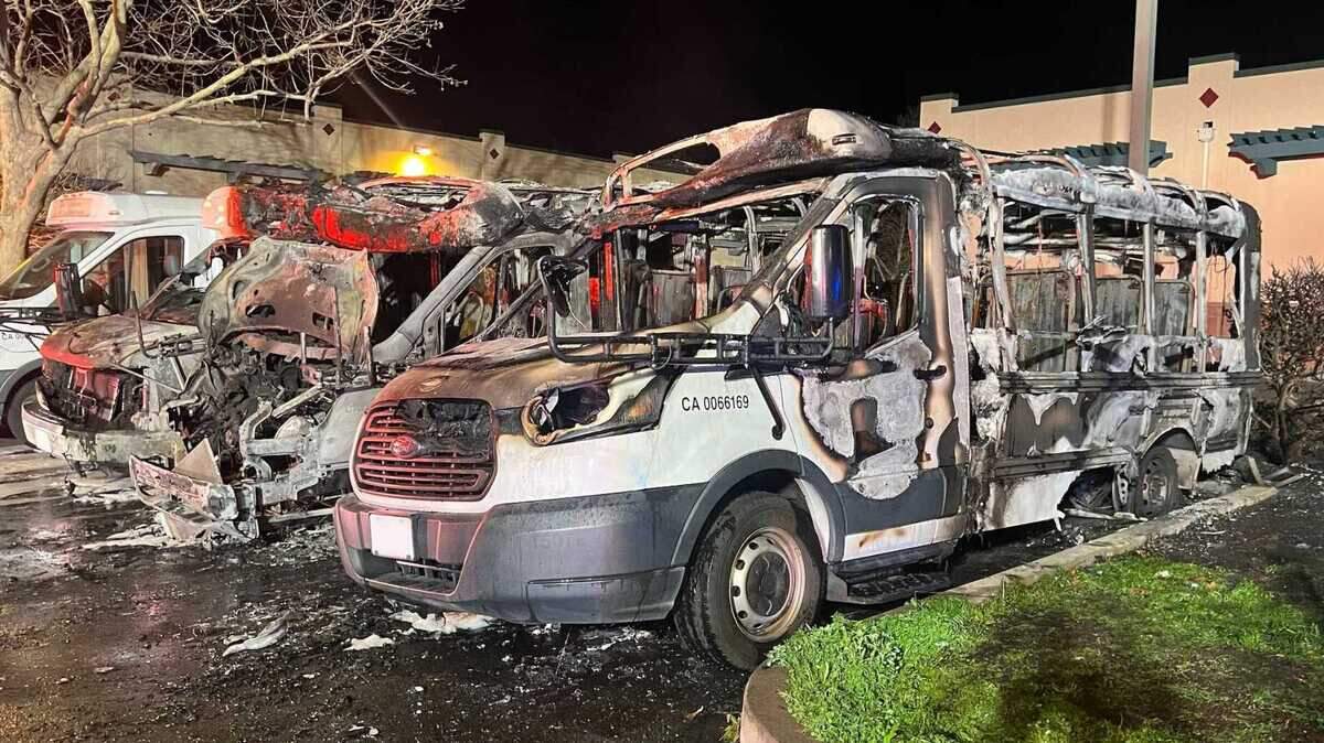 The remains of three buses are seen Sunday, Feb. 12, 2023, following a fire at Elk Grove KinderCare. Arson officials are investigating the incident.