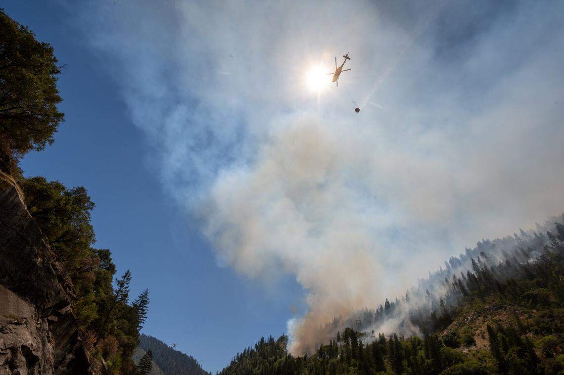 A Cal FIre helicopter drops water to battle the Dixie Fire near Highway 70 in the Feather River Canyon in Plumas County on Wednesday, July 14, 2021. The fire started near the origin of 2018’s deadly Camp Fire. In 2024, Cal Fire and the U.S. Forest Service responded to more than 2,800 wildfires in the state in the first half of the year, slightly more than last year’s roughly 2,500 fires to date.