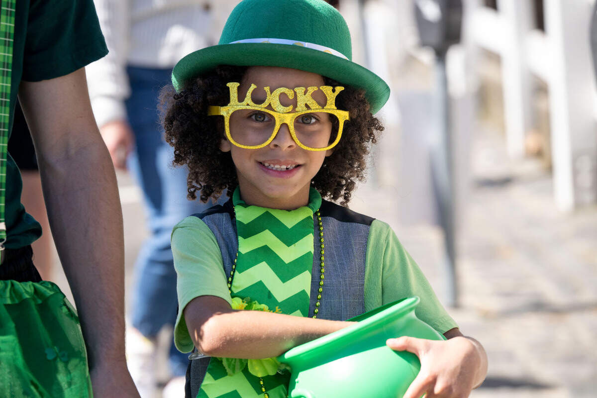 Khiernan Wint, 8, wears his lucky glasses while carrying a pot of candy at the St. Patrick’s Day parade in Old Sacramento on Saturday.