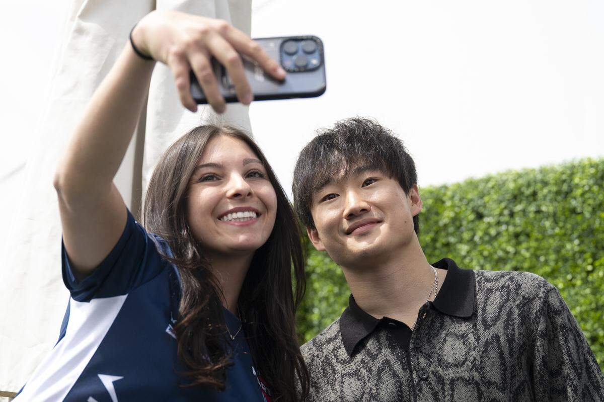 Sonia Shapiro, of Palo Alto, takes a selfie with Formula 1 driver Yuki Tsunoda during the Velocity Invitational at Sonoma Raceway in Sonoma on Saturday.