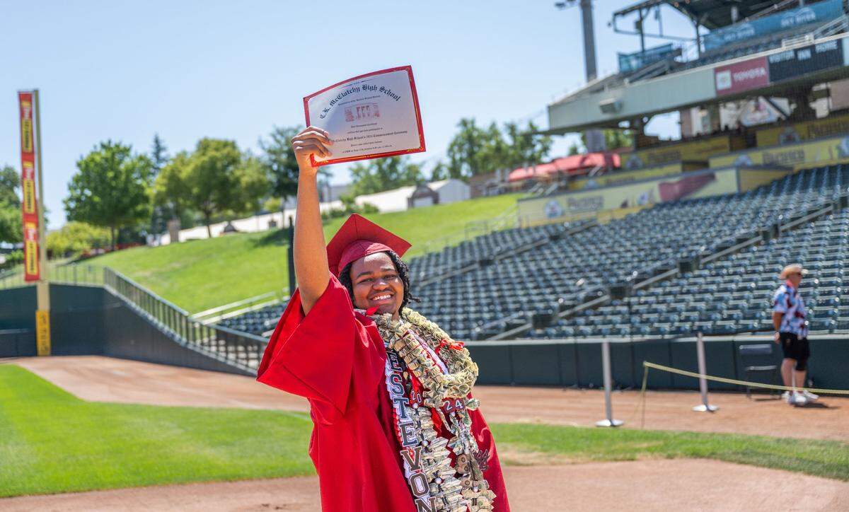 Estevan Bledsoe shows his diploma during the C.K. McClatchy commencement ceremony Tuesday.
