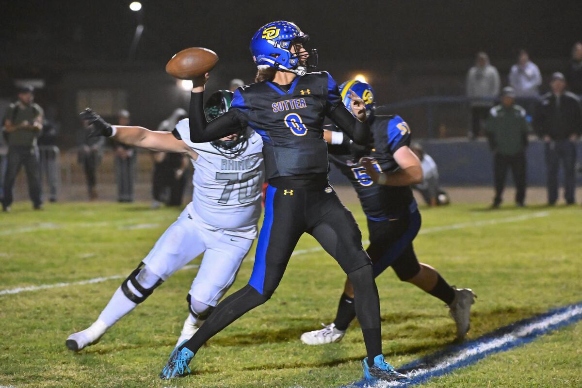 Sutter Huskies quarterback Jagger Beck (0) passes downfield in the first half against the Twelve Bridges Raging Rhinos on Thursday at Sutter Union High School.