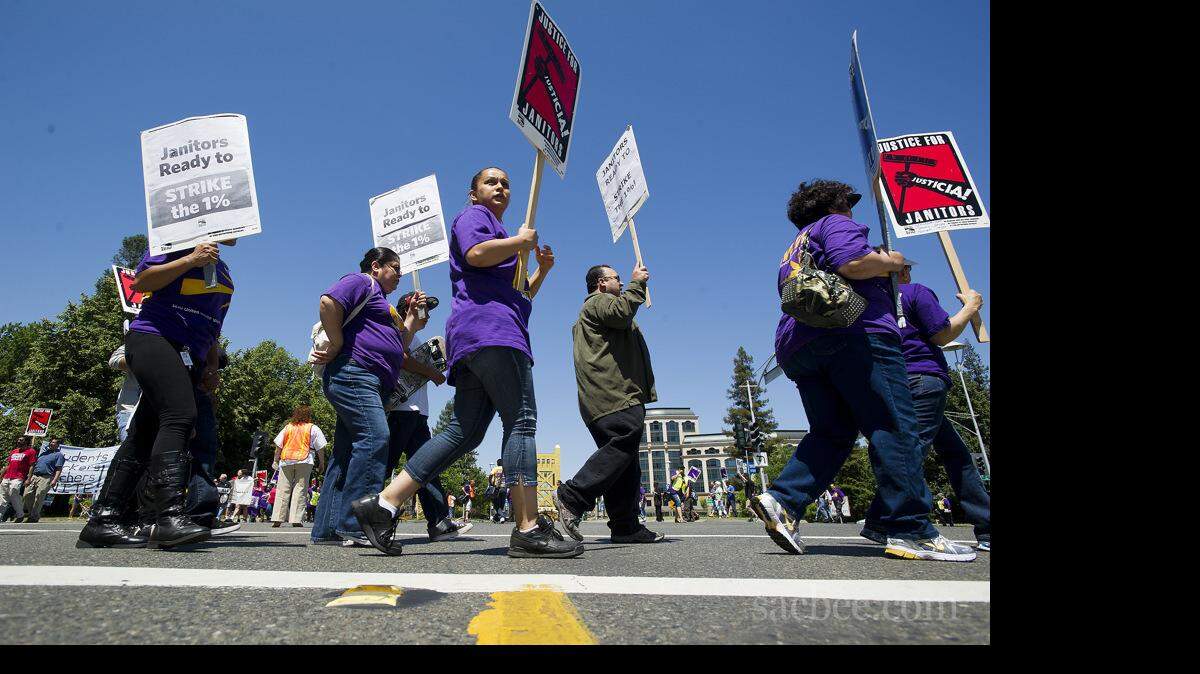 Janitors represented by the Service Employees International Union and their supporters protest in 2012.