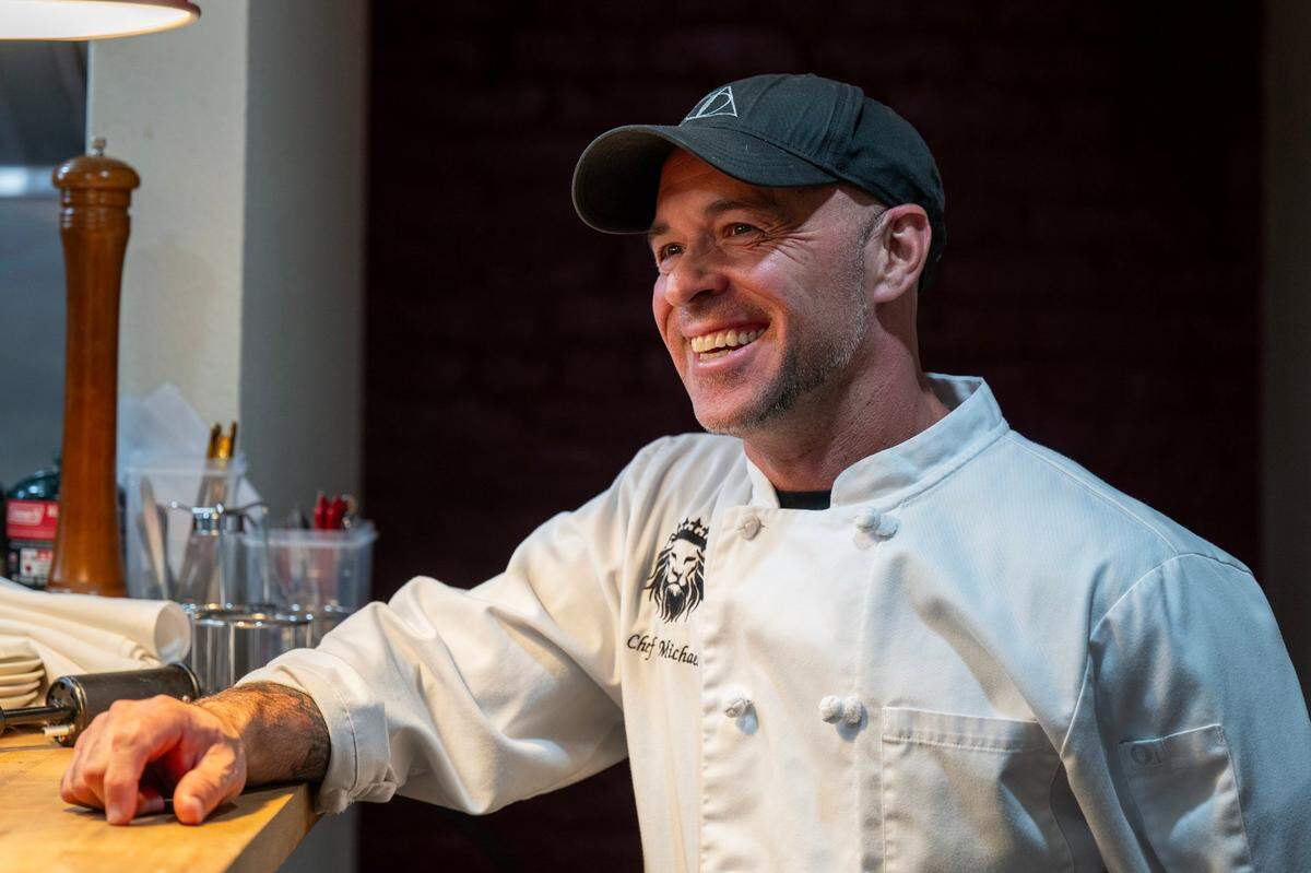 Chef/owner Michael McDermott visits with customers at Daniello’s speakeasy in Roseville on Friday.