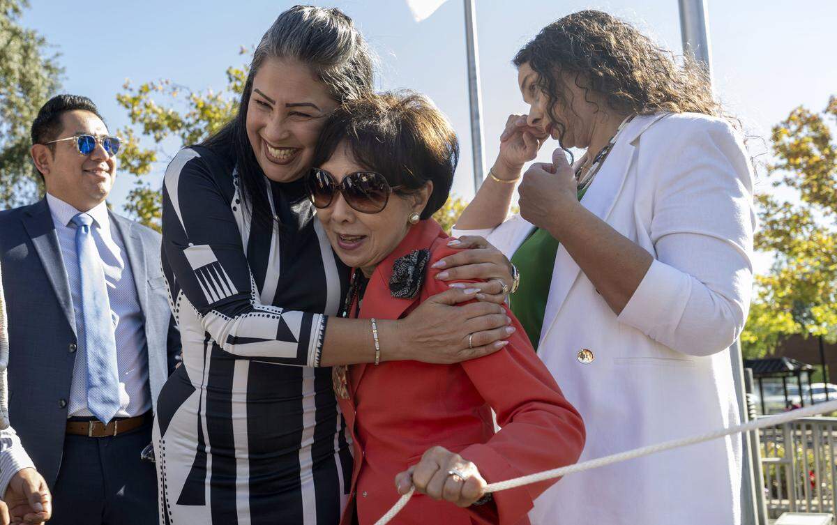 Reina Lisbet Hernandez Tarango hugs Rep. Doris Matsui, D-Sacramento, as Elk Grove Mayor Bobbie Singh-Allen holds back tears after raising the flag of the Wilton Rancheria at Elk Grove City Hall on Monday.