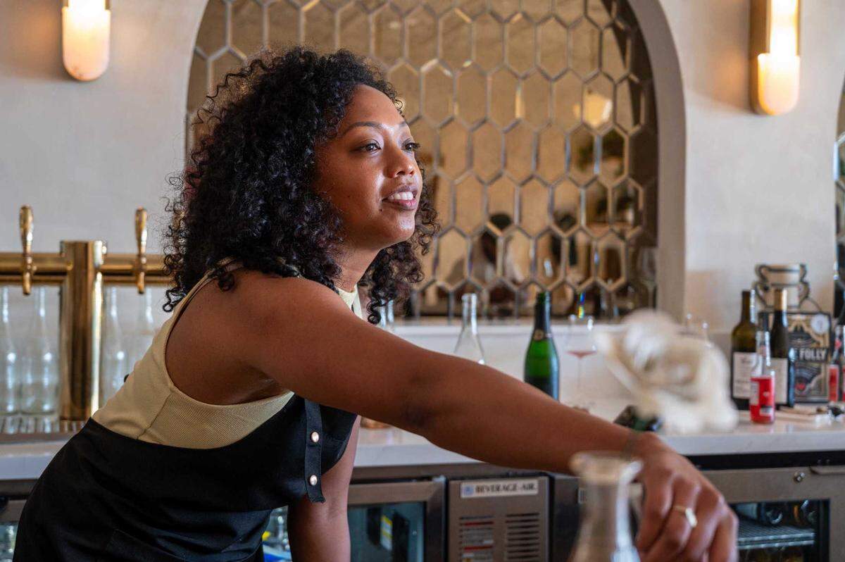 Co-founder and wine curator Nadia Mincey refills glass at Ever After Wine in Elk Grove on Wednesday.