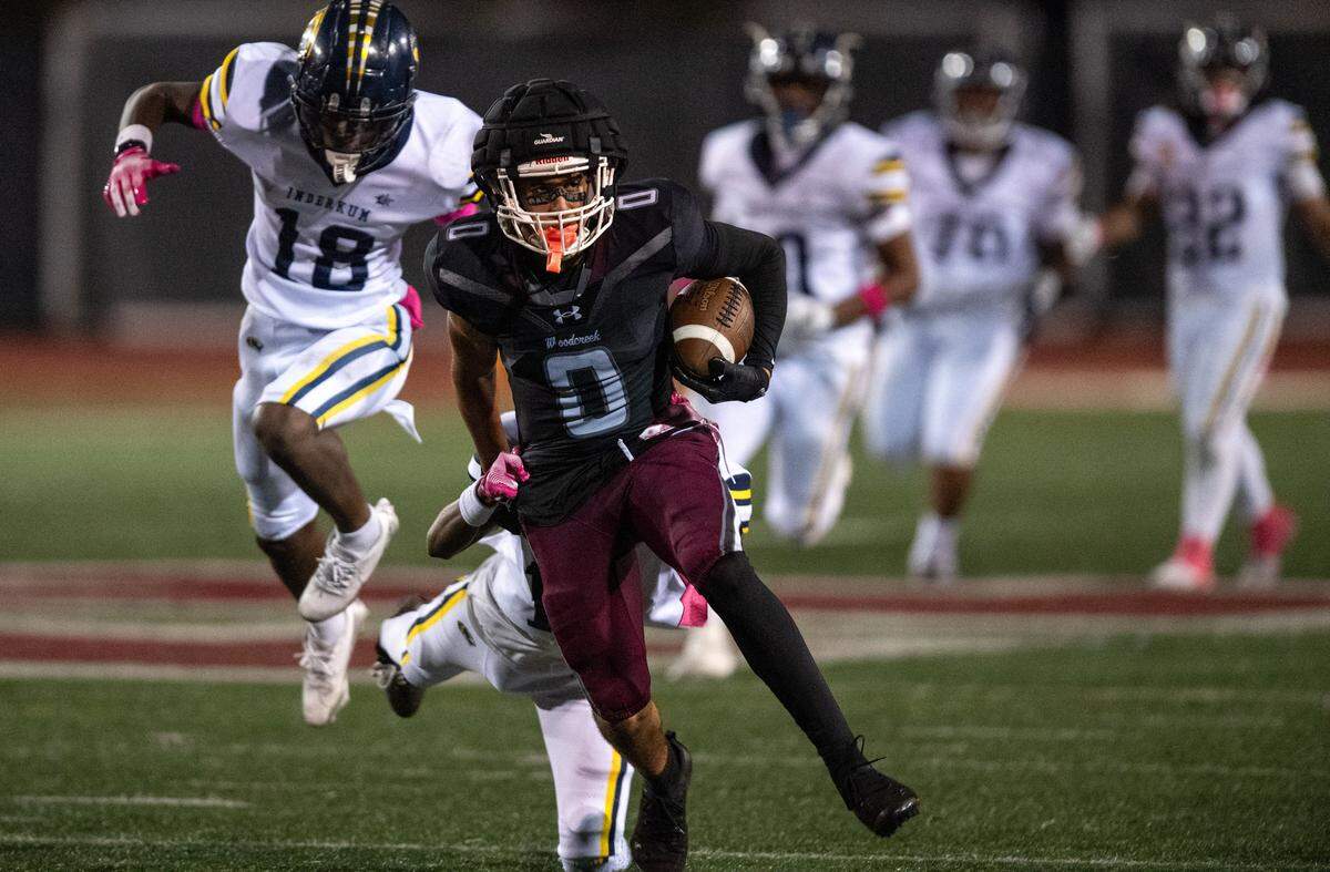 The Woodcreek Timberwolves' Trace Murchison (0) picks up first down yardage on a reception in the fourth quarter against the Inderkum Tigers on Oct. 17. 