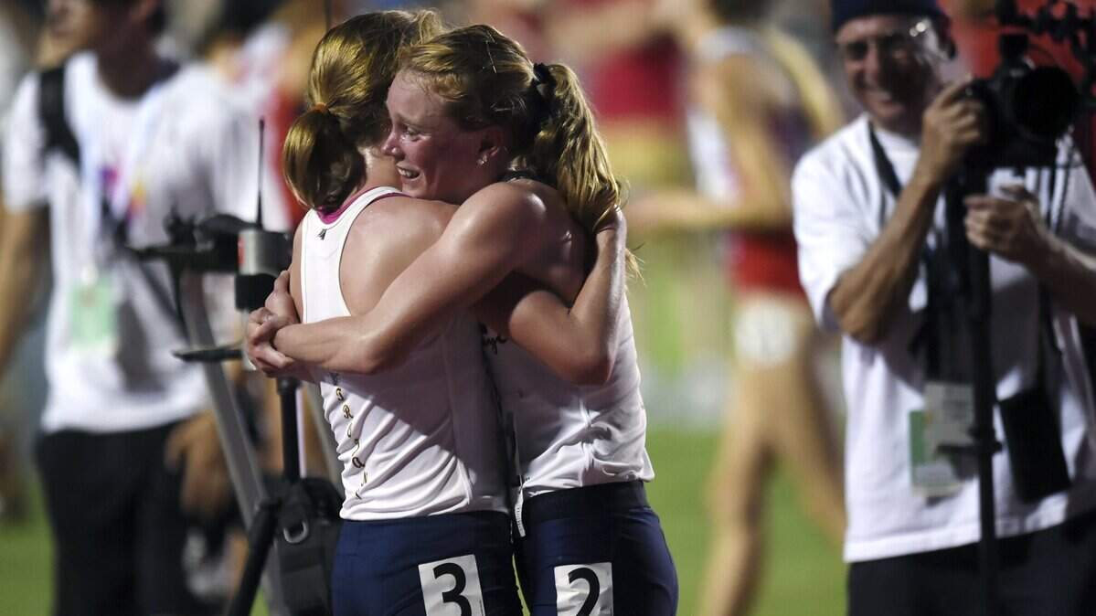 Oak Ridge's Maddy Denner, left, hugs twin sister Elena Denner after the girls' 3,200 race at the CIF State Track and Field Championships on Saturday in Clovis.