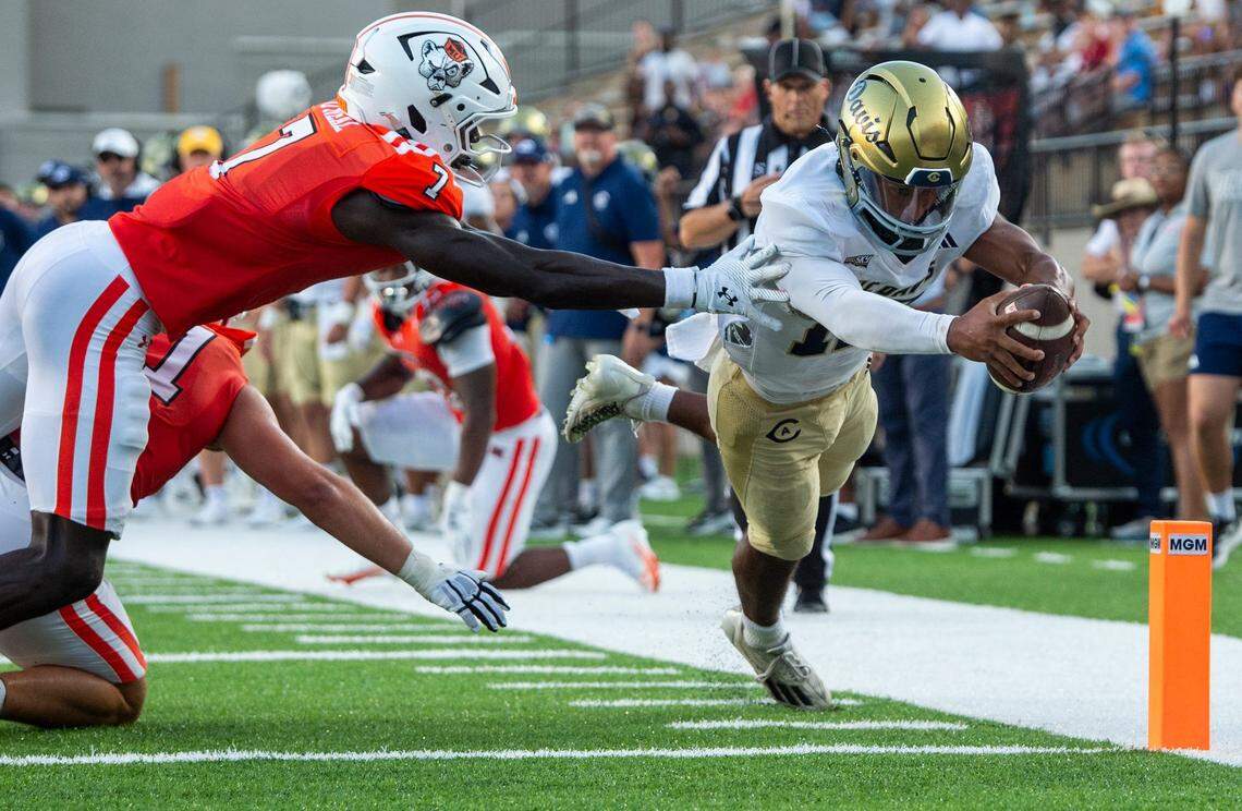 UC Davis Aggies quarterback Caden Pinnick (12) dives across the goal line for a touchdown as Mercer Bears take on UC Davis Aggies during the FCS Kickoff Game at Cramton Bowl in Montgomery, Ala. on Saturday, Aug. 23, 2025.