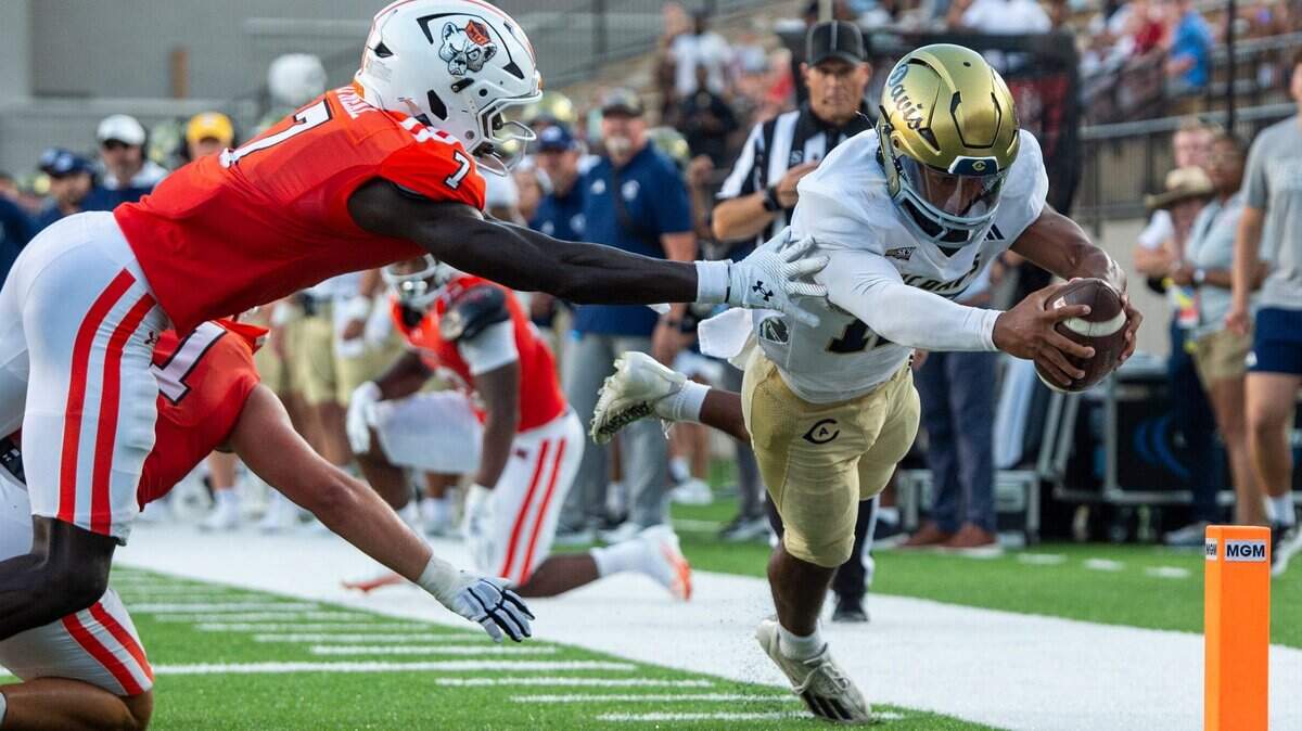 UC Davis Aggies quarterback Caden Pinnick (12) dives across the goal line for a touchdown as Mercer Bears take on UC Davis Aggies during the FCS Kickoff Game at Cramton Bowl in Montgomery, Ala. on Saturday, Aug. 23, 2025.