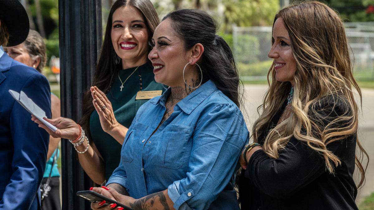 Sonja Shaw, left, president of Chino Valley Unified School District, applauds with Freedom Angels co-founders Denise Aguilar, center, and Tara Thornton after speaking at a news conference at the state Capitol on Monday, Aug. 14, 2023. The women spoke in opposition to a series of education bills, many supportive of the LGBTQ community, that they say would infringe on parental rights and remove local control in school districts.