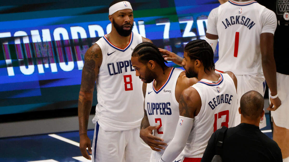 Los Angeles Clippers forward Marcus Morris Sr. (8) and guard Paul George (13), right, congratulate forward Kawhi Leonard (2) after they defeated the Dallas Mavericks in Game 6 of an NBA basketball first-round playoff series in Dallas, Friday, June 4, 2021. (AP Photo/Michael Ainsworth)