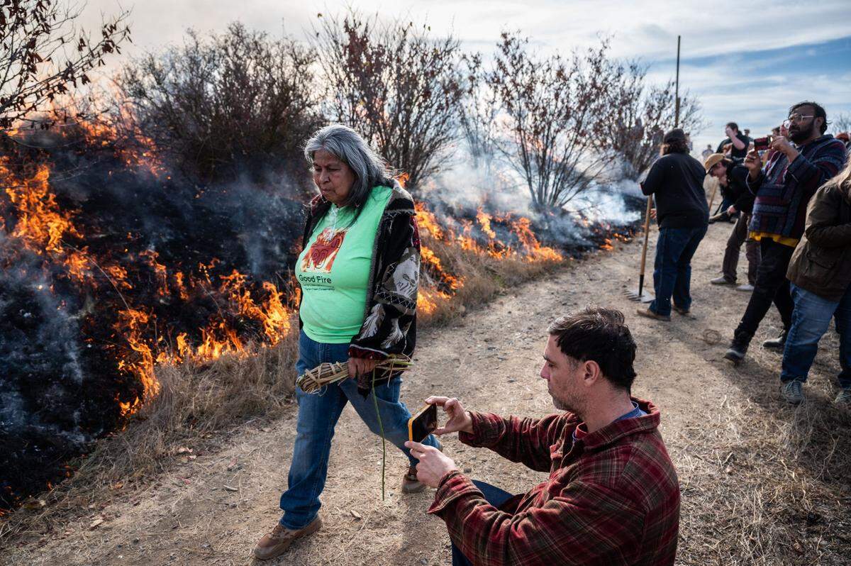 Maidu/Wintun cultural expert Diana Almendariz walks past the cultural burn that she was directing Friday at the Cache Creek Nature Preserve in Yolo County. The small fires of the Leok Po (Wintun for “good fire”) demonstration benefit culturally valuable native plants.