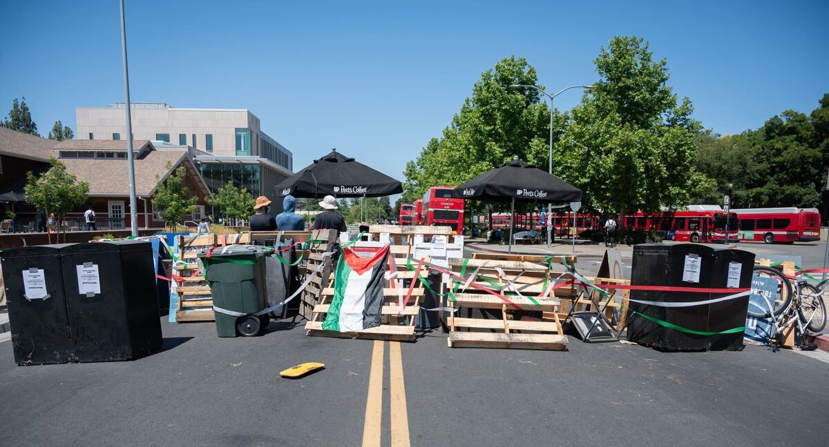 A barricade erected by pro-Palestinian protesters blocks the road in front of a Unitrans bus terminal along Hutchison Drive at UC Davis on Monday. While this terminal was not able to operate, other Unitrans buses were active on the campus.