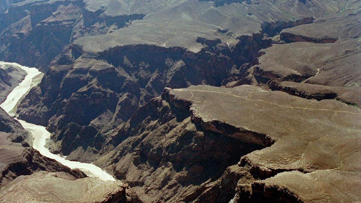 A Grand Canyon boater died after the boat flipped in rapids on the Colorado River, park rangers said.