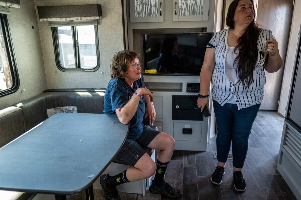Sharon Jones, seated, one of Camp Resolution’s founders, and Crystal Sanchez, president of the Sacramento Homeless Union, check out a new trailer delivered by the city of Sacramento to the self governing homeless encampment on Monday in North Sacramento. Sanchez said the trailer, the first of dozens expected to be delivered, will be used for administrative purposes.