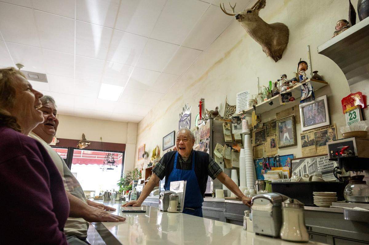 Paul Fong talks with customers Rick and Lynn Bunfill as they wait for their deluxe combo order and ginger beef.