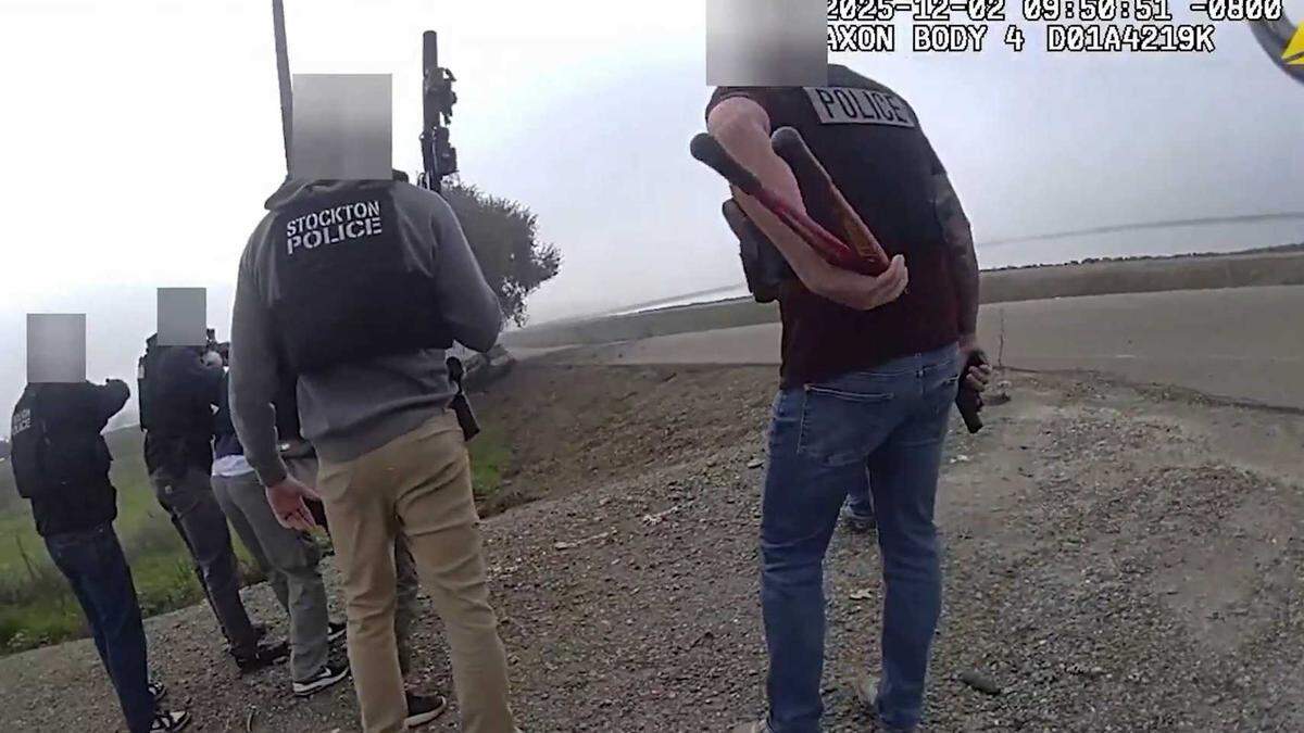 Deputies and officers from multiple agencies move toward Marvin Morales after he was shot during a standoff along Interstate 5, as seen in body-worn camera footage released Friday, Jan. 17, 2026, by the Sacramento County Sheriff’s Office.
