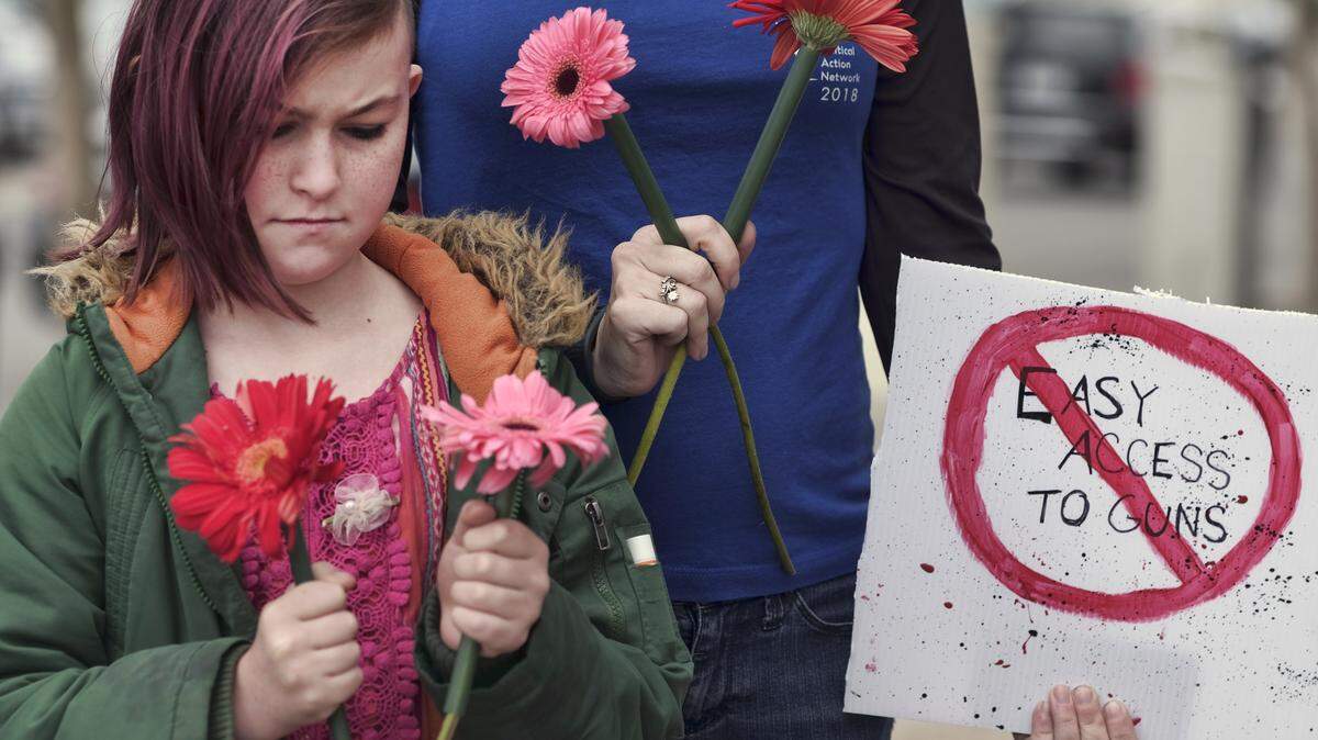 Student Tanner McPherson, 10, pauses for a moment of silence during a student protest in the Studio City section of Los Angeles on Sunday. The student-activist group "No Guns LA" held a rally to call for stricter gun control laws. Students across the country will hold protest gun violence on Wednesday during the National School Walkout.