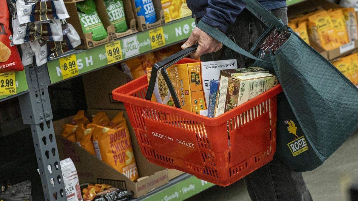 A shopper holds a basket with groceries inside a store in San Francisco in a 2022 photo. Bloomberg photo by David Paul Morris.