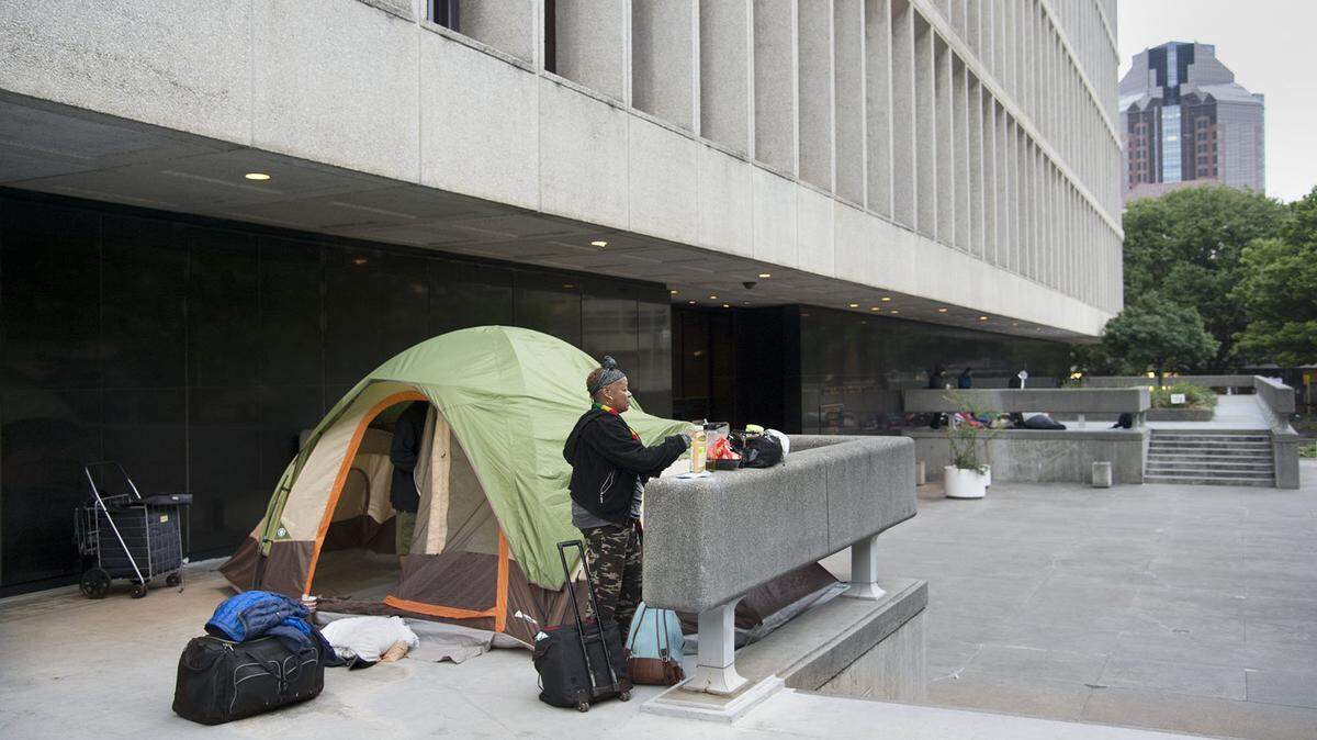 In 2017, campers pack up after being asked to vacate the sidewalks outside the Sacramento County courthouse in Sacramento.