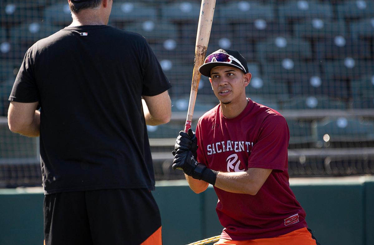 Then-River Cats infielder Mauricio Dubon talks with coach Damon Minor at then-Raley Field, now Sutter Health Park, in August 2019 in West Sacramento. Dubon now plays for the Houston Astros.