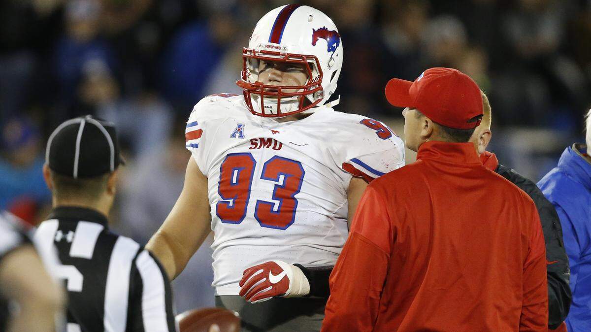 SMU defensive end Mason Gentry (93) is helped off the field during an NCAA college football game between SMU and Tulsa in Tulsa, Okla., Friday, Oct. 7, 2016.