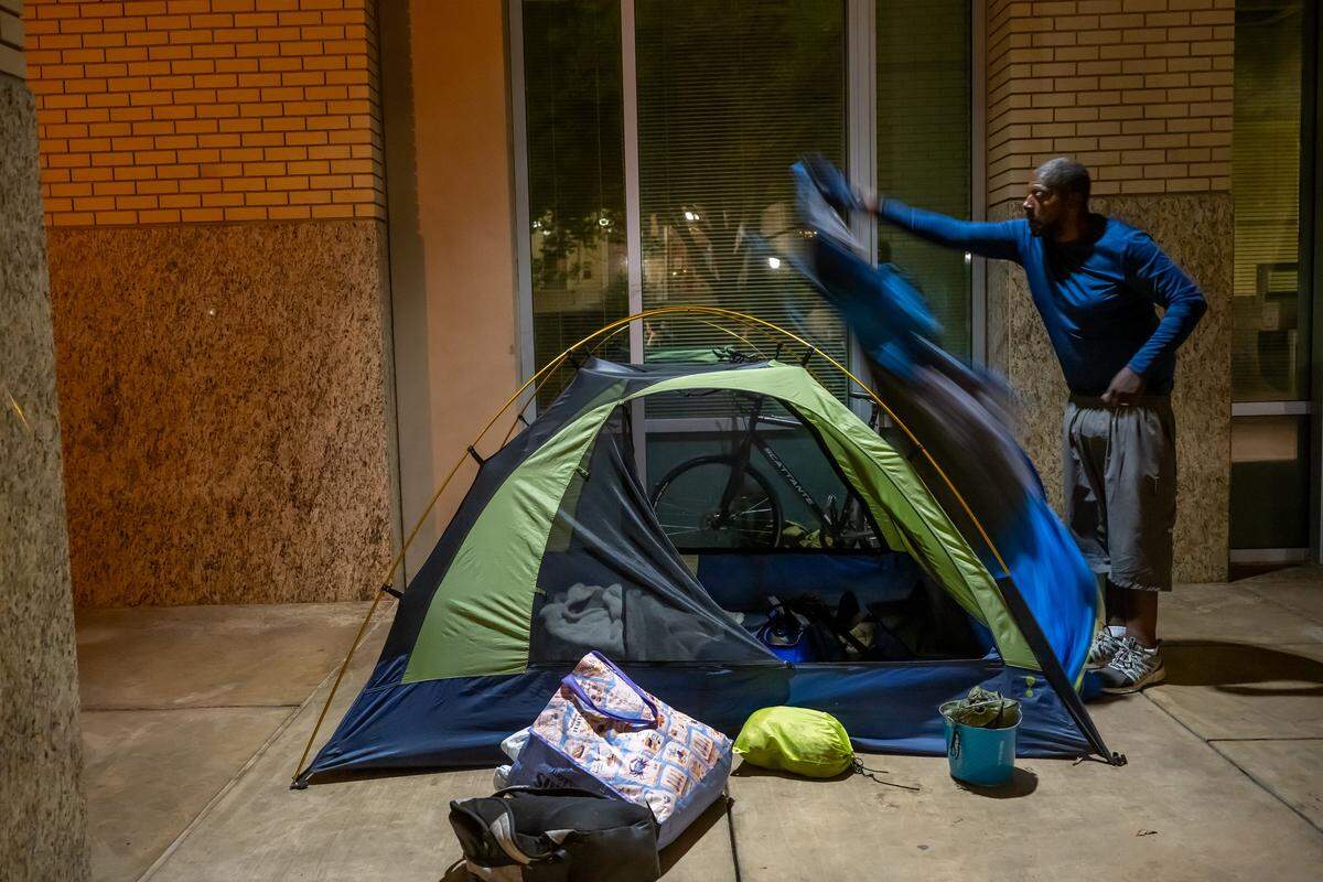 Gary Kelly, 68, who suffers from incontinence and says shelters ask him to leave, prepares his tent outside Sacramento City Hall on Wednesday, Aug. 27, 2025, not knowing where he would go after a city ordinance banning sleeping at the building took effect the next day. He and his partner of nine years had been sleeping there for the past year. He said they regularly call 211, the region's primary homeless services number, with no results.