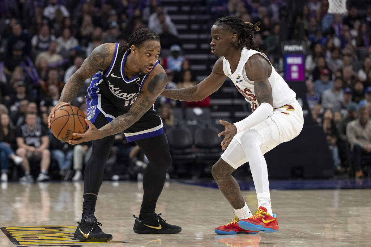 Cleveland Cavaliers guard Keon Ellis (14) defends Sacramento Kings guard DeMar DeRozan (10) during a game at Golden 1 Center in Sacramento on Saturday. Ellis was recently traded to the Cavs from the Kings.