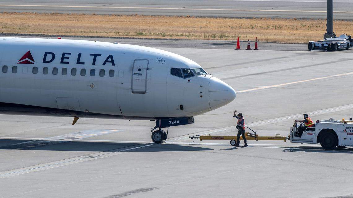 A ground crew prepares a Delta Air Lines plane for flight in 2024 at Sacramento International Airport. The Atlanta-based carrier announced it would suspend its direct route between Sacramento and Detroit as part of broader network adjustments.