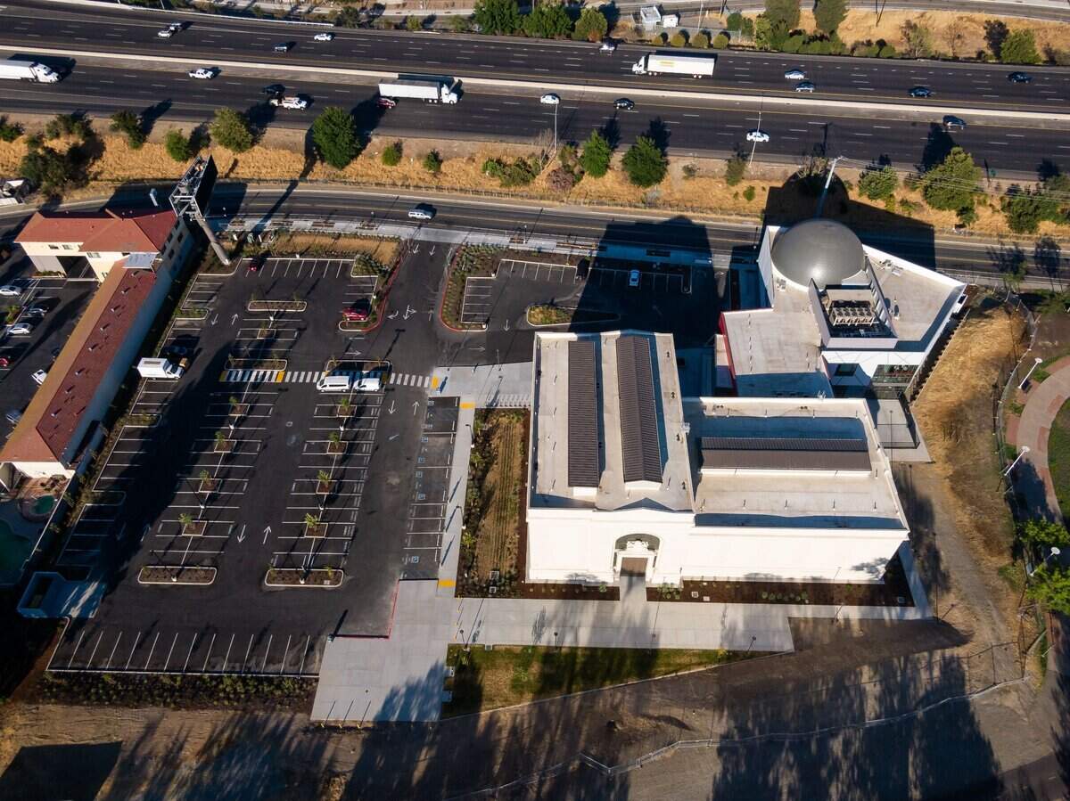 The new SMUD Museum of Science and Curiosity, photographed by drone on July 20, 2021, occupies the former PG&E steam-turbine powerhouse in Sacramento between Interstate 5 and the Sacramento River.