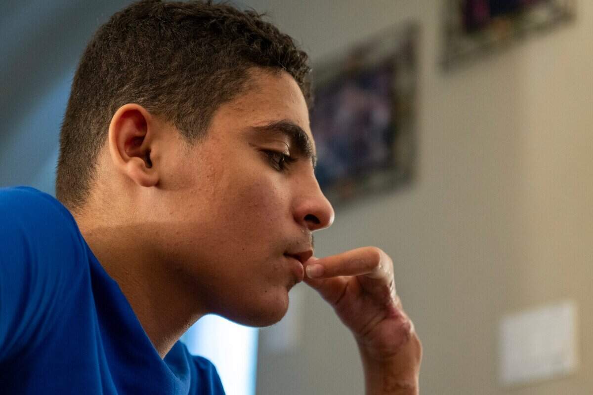 Ahmed listens last month in Folsom to his mother talk about their experience of living in Gaza. Ahmed sustained injuries, including the loss of both legs, last February, during a bombing near a farm where he, his brother, and a friend were outside walking. His friend was killed and both he and his brother were severely injured.