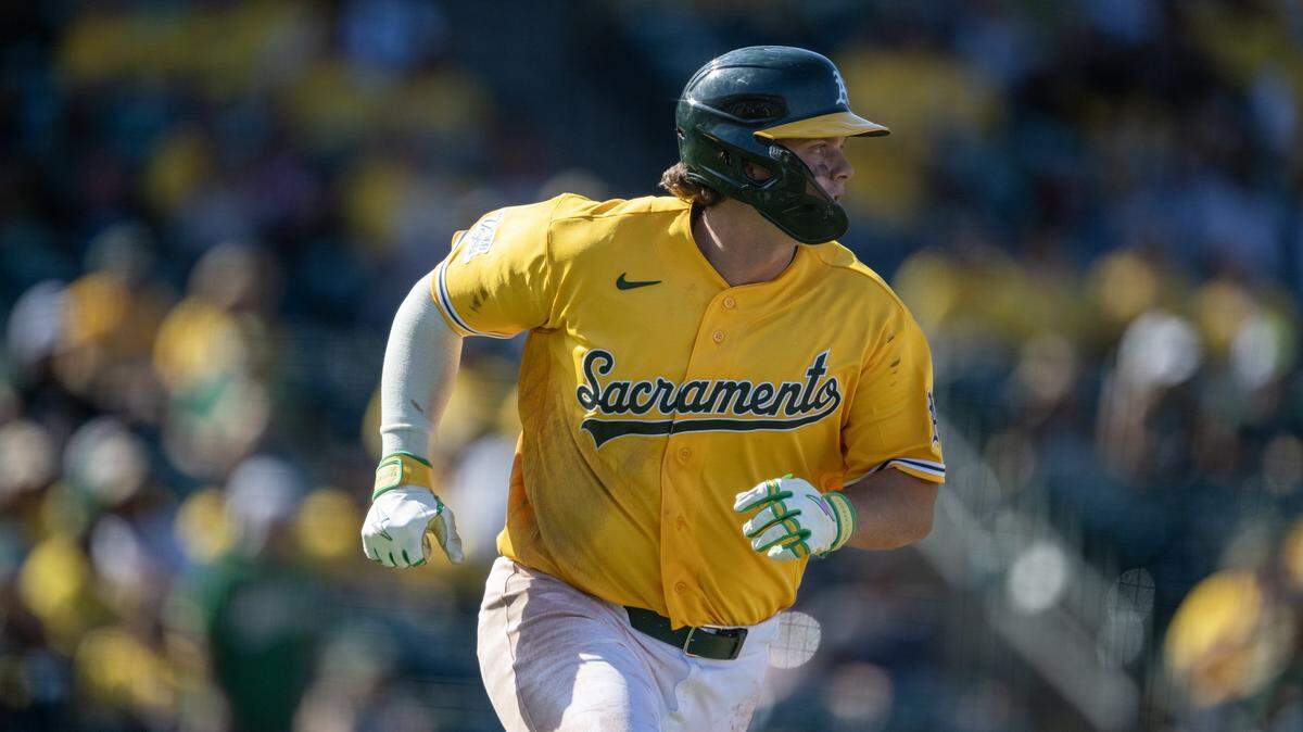 Athletics first baseman Nick Kurtz hits a single in the eighth inning of a game Saturday against the Houston Astros at Sutter Health Park in West Sacramento. The team debuted its gold “Sacramento” alternate jerseys, also giving them away to fans in attendance.