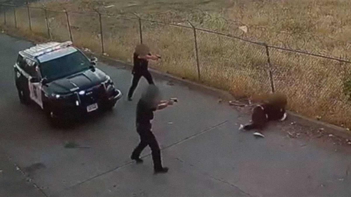 In an image taken from surveillance video and released by the Sacramento Police Department, two officers are seen firing their weapons after a woman suspected of assault stabbed an officer with knife on Aug. 27, 2022. The woman died and the stabbed officer is recovering from his wounds.