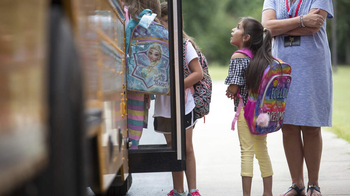 Children in Kentucky board the bus on their first day of school Aug. 8. Students in a Colorado school district returned to class Tuesday as part of an experimental four-day school week to save money and help recruit teachers.