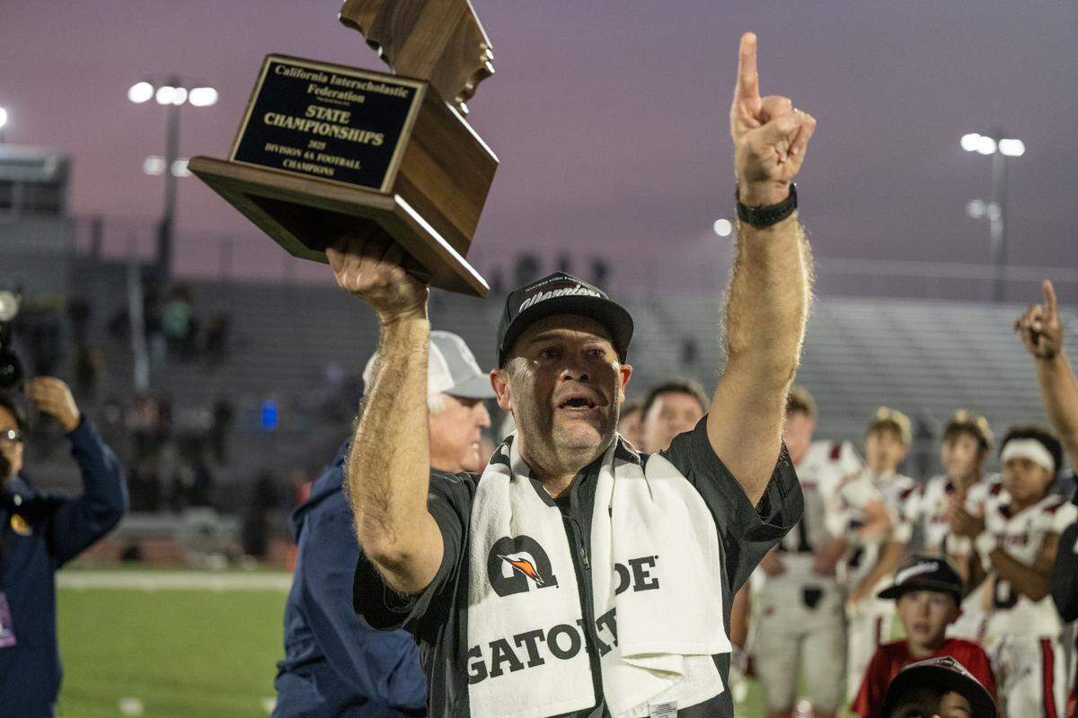 Winters Warriors coach Daniel Ward points toward the stands full of supporters following the 28-7 victory over the Morse Tigers in the CIF Division 6-A State Championship football game at Buena Park High School in Buena Park on Saturday.