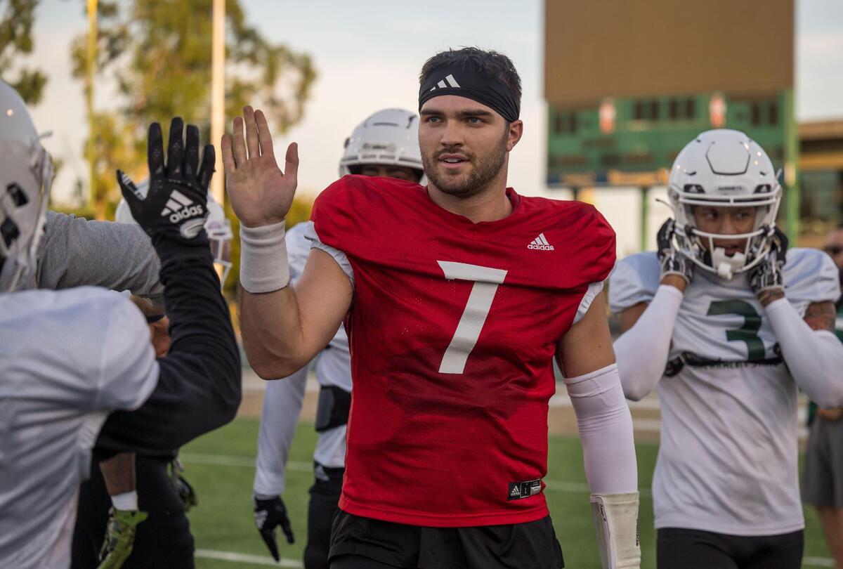 Sacramento State quarterback Carson Camp is congratulated on the sideline after a touchdown pass during a football scrimmage earlier this month at Hornet Stadium.