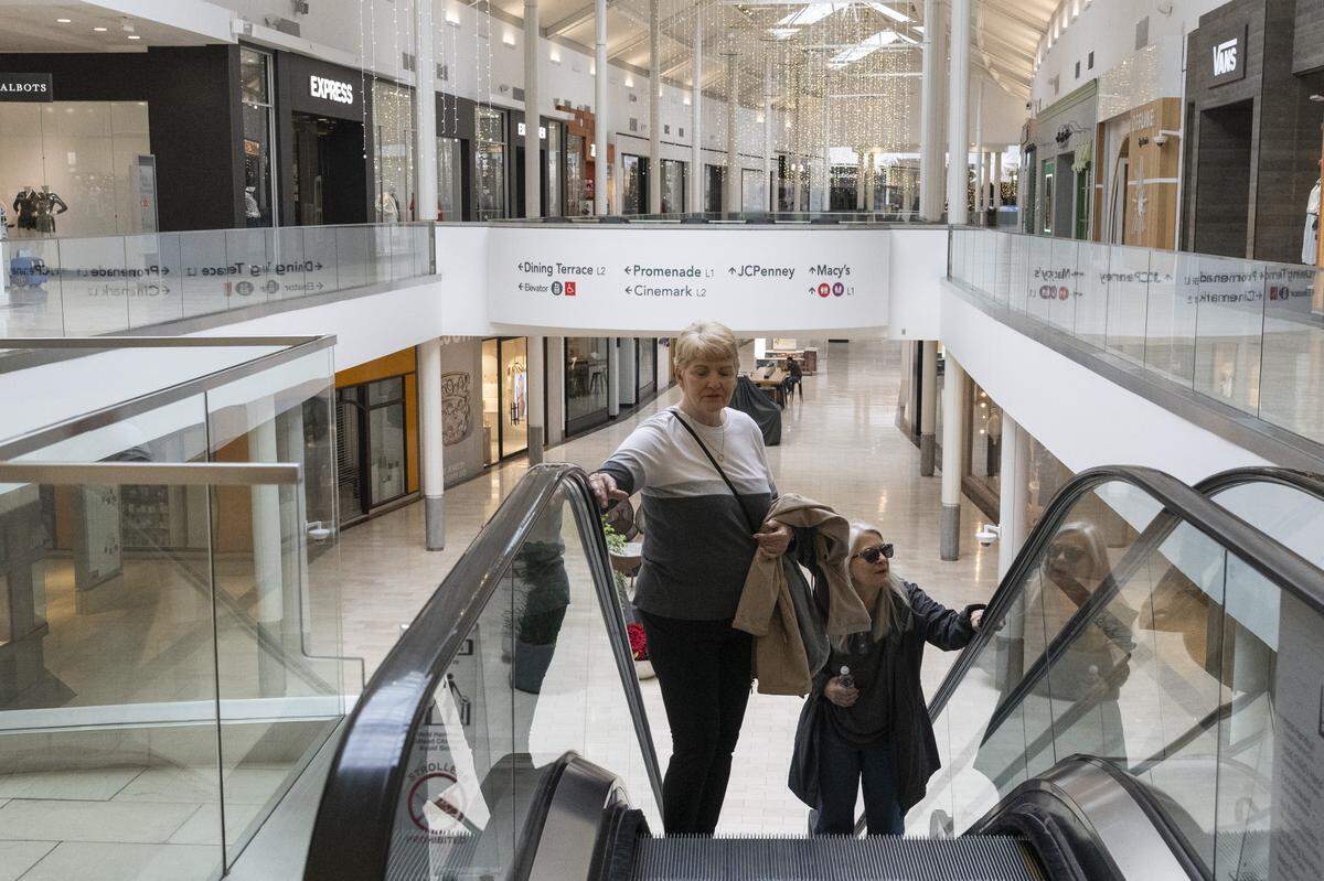 Shoppers take the escalator at the Roseville Galleria on Wednesday.
