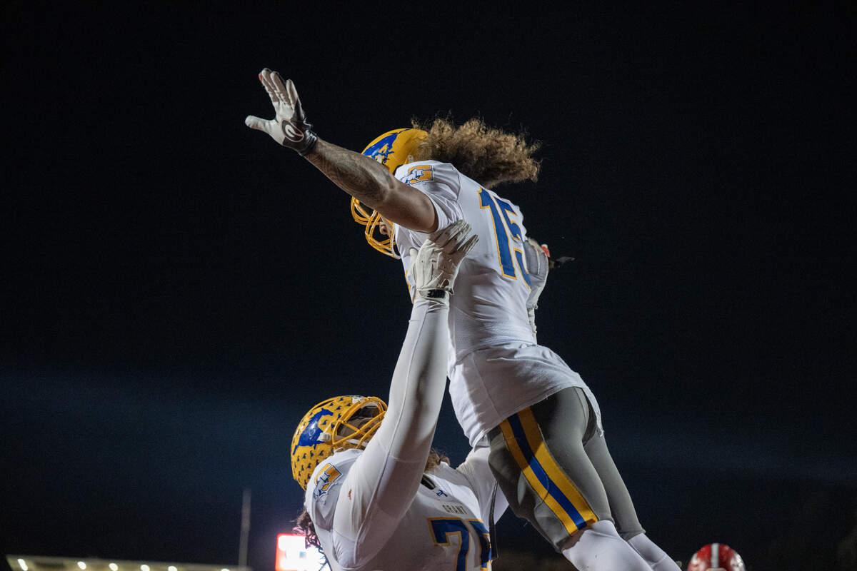 The Grant Pacers' Tyron Carter (15) celebrates with Roger Vanderhoef (75) after scoring a touchdown against the Cordova Lancers in the second half on Thursday, Oct. 30, 2025, in Rancho Cordova.